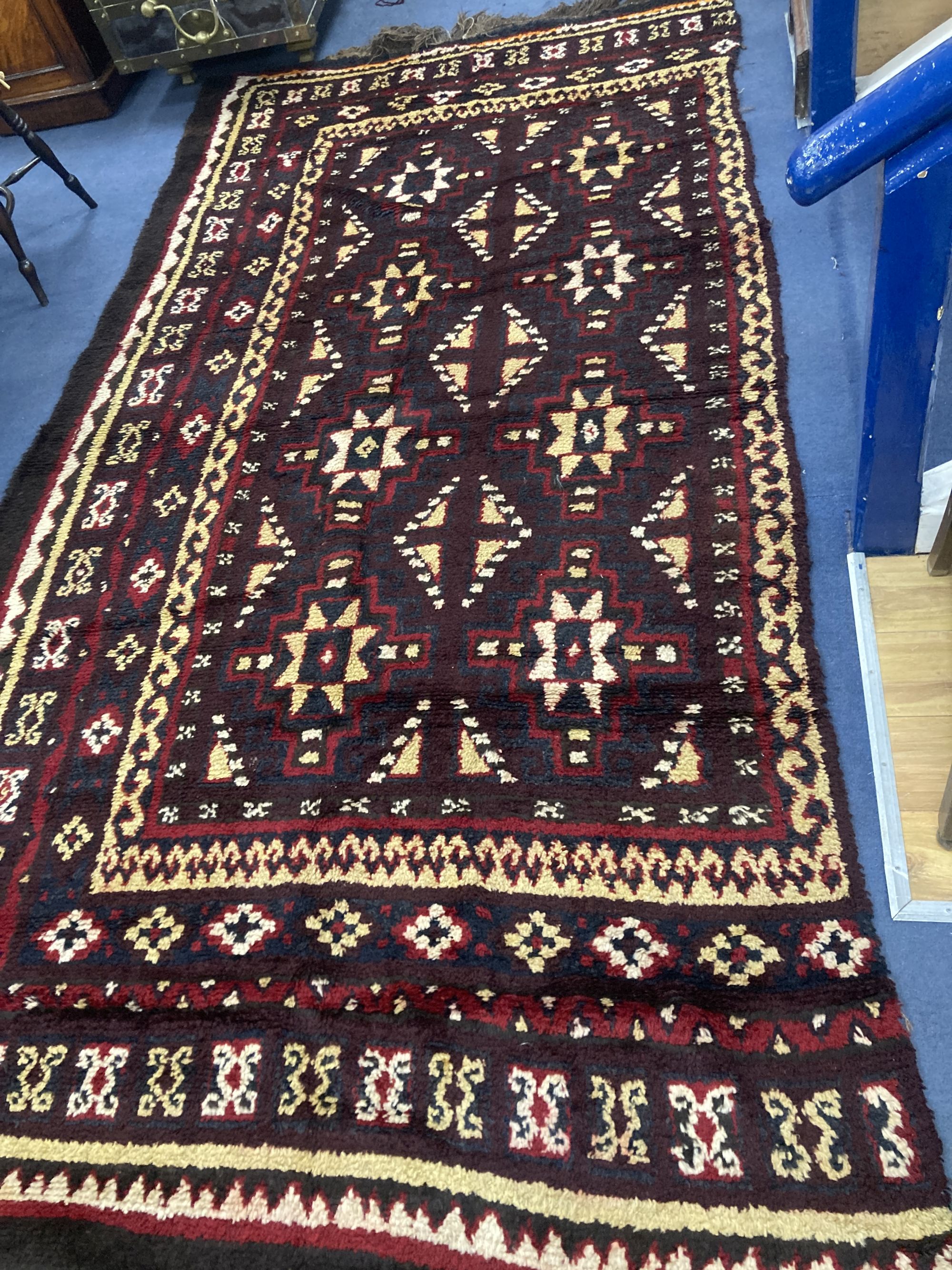 A central Asian wool carpet, 350 x 220cm (in two sections)